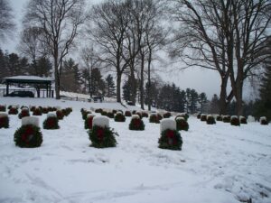The spirit of the holiday season arrives early in Bath this year with the arrival of the Wreaths Across America (WAA) Truck on Monday, December 2nd. This nationwide program honors our fallen veterans by placing wreaths on the headstones at Arlington National Cemetery and over 2,500 additional locations across the country, including Bath National Cemetery.